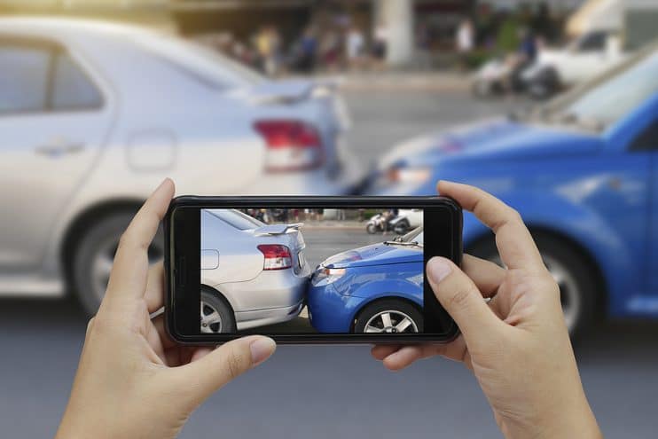 Taking photo of car crash