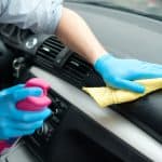 man cleaning car interior