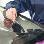 Close Up Car Glaze Worker Fixing And Repairing A Windshield Or W