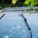 Car Windshield With Rain Drops And Frameless Wiper Blade