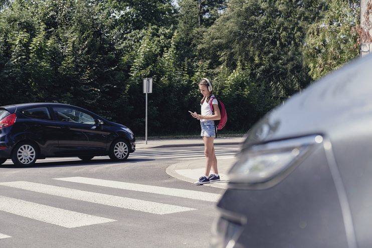 Pedestrian wearing headphones