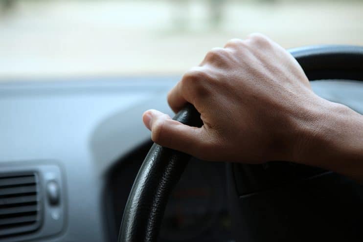 Hand on steering wheel